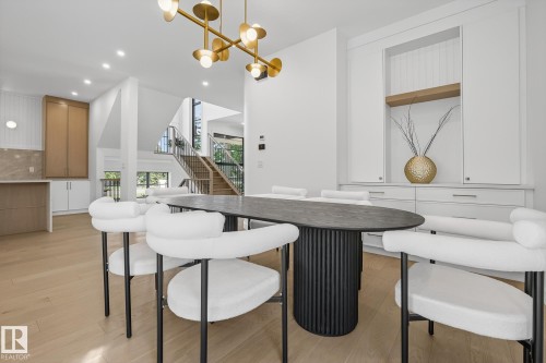 Dining area featuring wood-finish flooring and a contemporary chandelier - 13804 85 Avenue, Edmonton, AB - Indoor Photo Showing Dining Room