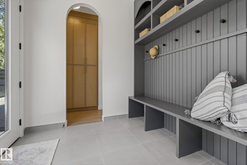 Built-in mudroom bench with vertical paneling, integrated shelving, and coat hooks - 13804 85 Avenue, Edmonton, AB -  Photo Showing Other Room