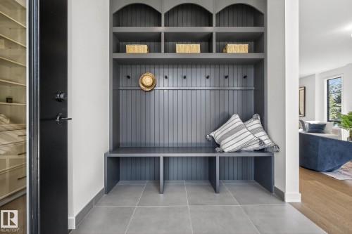 Custom built-in hall tree featuring beadboard paneling, integrated bench seating, multiple storage cubbies, and coat hooks - 13804 85 Avenue, Edmonton, AB - Indoor Photo Showing Other Room