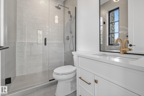 Bathroom featuring a glass-enclosed shower with subway tile surround, rainfall showerhead, and handheld sprayer - 13804 85 Avenue, Edmonton, AB - Indoor Photo Showing Bathroom