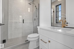 Bathroom featuring a glass-enclosed shower with subway tile surround, rainfall showerhead, and handheld sprayer - 