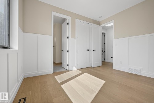 Room featuring light wood-finish flooring and wainscoting - 13804 85 Avenue, Edmonton, AB - Indoor Photo Showing Other Room