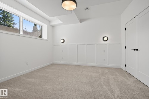 Carpeted interior space featuring white walls and wainscoting - 13804 85 Avenue, Edmonton, AB - Indoor Photo Showing Other Room