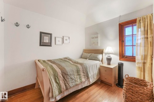 Hardwood flooring with a rich finish - 5043 48 St Nw, Sylvan Lake, AB - Indoor Photo Showing Bedroom