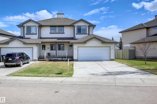 Two-story property with white siding and dark trim accents - 8129 7 Avenue, Edmonton, AB - Outdoor With Deck Patio Veranda With Facade