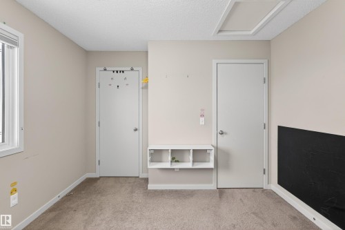 Interior room featuring neutral wall paint, light-colored carpet flooring, and white trim - 4723 Alwood Bend Sw, Edmonton, AB - Indoor Photo Showing Other Room