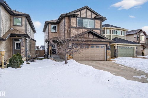 Two-story residence featuring a tan garage door and stone accents - 4723 Alwood Bend Sw, Edmonton, AB - Outdoor With Facade