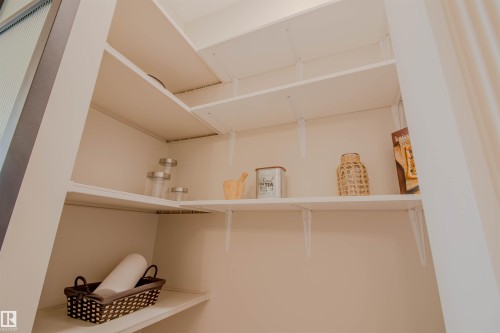 Integrated pantry shelving system featuring adjustable shelves and white finishes - 5935 189 Street, Edmonton, AB - Indoor