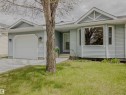 Light blue siding exterior featuring a single-car garage with overhead door, a prominent bay window, and a gabled roofline with decorative trim - 5935 189 Street, Edmonton, AB  - Outdoor 