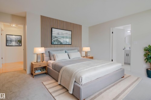 Bedroom featuring a slatted wood accent wall and light-colored carpeting - 5935 189 Street, Edmonton, AB - Indoor Photo Showing Bedroom