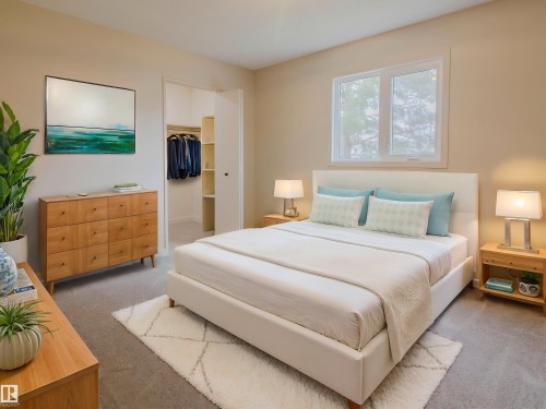 Carpeted bedroom with a window, built-in closet with shelving, and light-toned wall paint - 5935 189 Street, Edmonton, AB - Indoor Photo Showing Bedroom