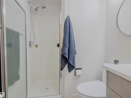 Modern bathroom featuring a glass-enclosed shower with chrome fixtures - 5935 189 Street, Edmonton, AB - Indoor Photo Showing Bathroom