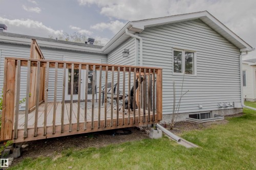 Expansive rear deck with natural wood railing and privacy wall - 5935 189 Street, Edmonton, AB - Outdoor With Deck Patio Veranda With Exterior