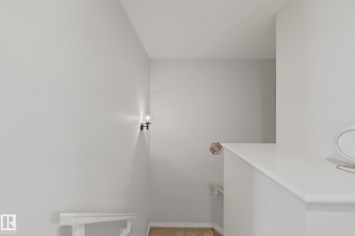 White painted walls with a wall sconce providing illumination - 1231 Watt Drive, Edmonton, AB - Indoor
