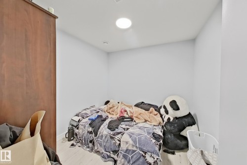 Recessed ceiling lighting illuminates a room featuring light-toned walls and wood-finish flooring - 1231 Watt Drive, Edmonton, AB - Indoor Photo Showing Bedroom