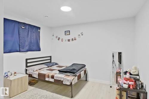 Light wood-finish flooring complements the neutral wall color - 1231 Watt Drive, Edmonton, AB - Indoor Photo Showing Bedroom