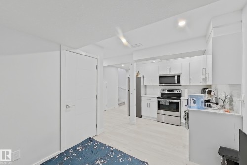 Contemporary kitchen space featuring white cabinetry and stainless steel appliances - 1231 Watt Drive, Edmonton, AB - Indoor Photo Showing Kitchen