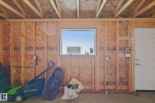 Unfinished interior space featuring exposed wood framing, oriented strand board walls, and overhead rafters - 1231 Watt Drive, Edmonton, AB - Indoor