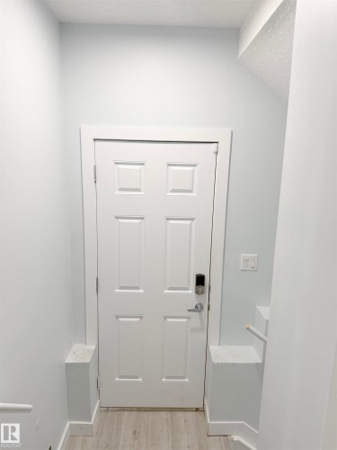 White paneled door with smart lock entry - 1231 Watt Drive, Edmonton, AB - Indoor Photo Showing Other Room