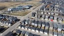 Aerial perspective showcasing a developed residential area with numerous detached properties and a contemporary institutional building - 1231 Watt Drive, Edmonton, AB  -  With View 