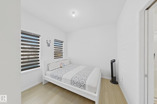 Bright room featuring light wood-finish flooring and white walls - 1231 Watt Drive, Edmonton, AB - Indoor Photo Showing Bedroom