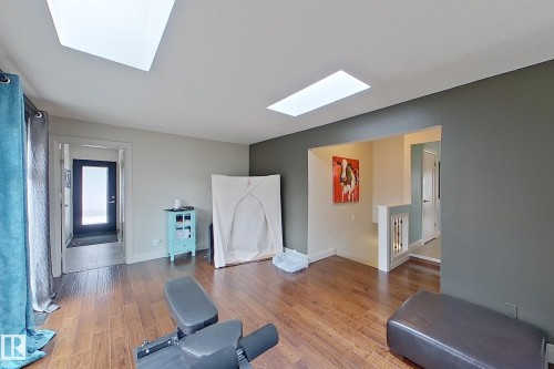 Hardwood-finish flooring complementing a neutral and accent wall color palette - 10 Brunswick Crescent, St. Albert, AB - Indoor