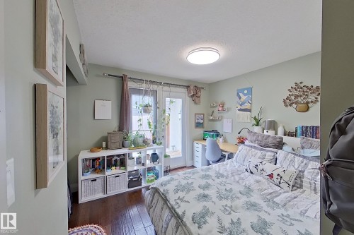 Bedroom featuring wood-finish flooring, light green wall tones, and a flush-mount ceiling light - 10 Brunswick Crescent, St. Albert, AB - Indoor Photo Showing Bedroom