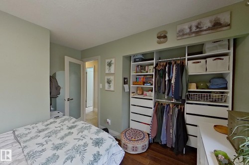 Integrated custom closet system with hanging rods, shelving, and drawer storage - 10 Brunswick Crescent, St. Albert, AB - Indoor Photo Showing Bedroom