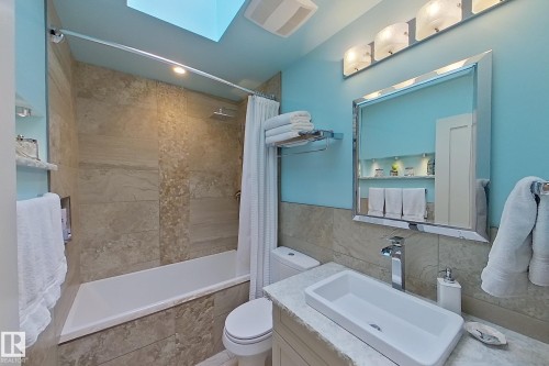 Bathroom featuring a white rectangular vessel sink, polished chrome faucet, and a large mirrored vanity - 10 Brunswick Crescent, St. Albert, AB - Indoor Photo Showing Bathroom