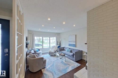 Living area featuring recessed lighting, dark wood-finish flooring, and a multi-pane window - 10 Brunswick Crescent, St. Albert, AB - Indoor
