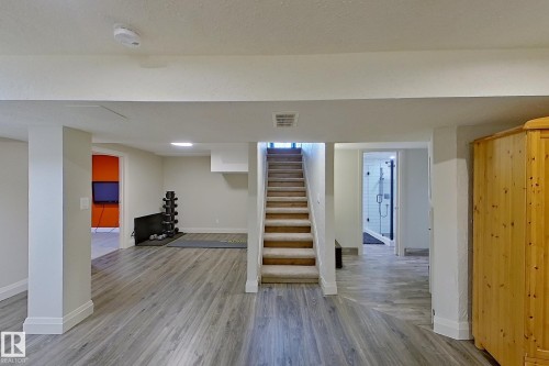 Finished lower level with wood-finish flooring, recessed lighting, and white trim - 10 Brunswick Crescent, St. Albert, AB - Indoor Photo Showing Other Room