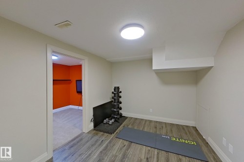 Versatile lower-level space featuring wood-finish flooring, a neutral color palette, recessed lighting, and white trim - 10 Brunswick Crescent, St. Albert, AB - Indoor Photo Showing Other Room