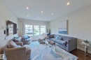 Spacious living area featuring expansive windows, recessed lighting, hardwood flooring, and light-toned walls - 10 Brunswick Crescent, St. Albert, AB  - Indoor Photo Showing Living Room 