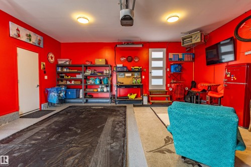 Attached garage featuring a light gray epoxy floor coating, two overhead door openers, and recessed lighting - 10 Brunswick Crescent, St. Albert, AB - Indoor Photo Showing Other Room