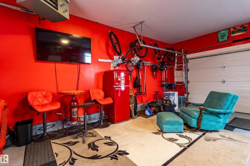 Attached garage interior with bright red painted walls - 10 Brunswick Crescent, St. Albert, AB - Indoor Photo Showing Garage