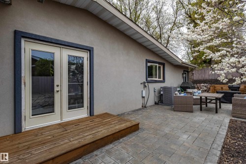 Patio access from double French doors, featuring a wood deck landing and a paver stone patio - 10 Brunswick Crescent, St. Albert, AB - Outdoor With Deck Patio Veranda With Exterior