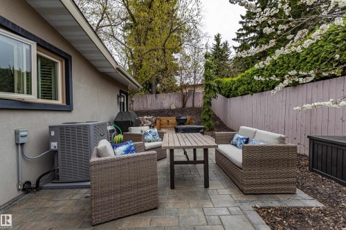 Paver patio space featuring a neutral stucco exterior, a privacy fence, and mature perimeter landscaping - 10 Brunswick Crescent, St. Albert, AB - Outdoor With Deck Patio Veranda With Exterior