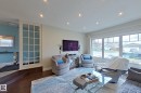 Living area featuring dark wood-finish flooring, recessed lighting, and a large picture window with transom detailing - 10 Brunswick Crescent, St. Albert, AB  - Indoor Photo Showing Living Room 
