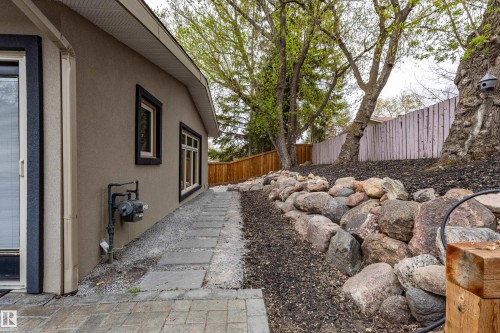 Stucco exterior featuring black trim windows and a sliding glass door - 10 Brunswick Crescent, St. Albert, AB - Outdoor