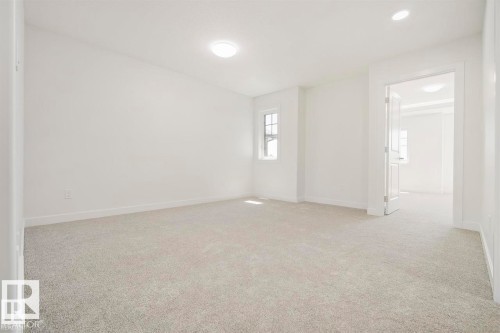 Carpeted room with a double-hung window, recessed lighting, and a flush mount ceiling fixture - 151 Kidd Crescent, Leduc, AB - Indoor Photo Showing Other Room