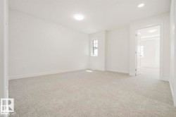 Carpeted room with a double-hung window, recessed lighting, and a flush mount ceiling fixture - 