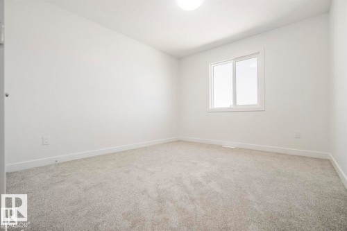 Bright room with light gray carpet, white walls, and a single window - 151 Kidd Crescent, Leduc, AB - Indoor Photo Showing Other Room