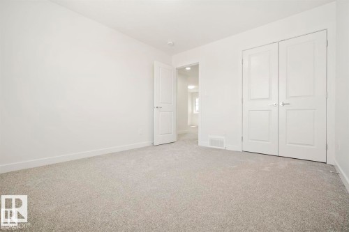 Interior room featuring neutral carpeting, white walls, and a recessed ceiling light fixture - 151 Kidd Crescent, Leduc, AB - Indoor Photo Showing Other Room