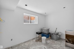 Spacious room featuring a white-framed window, recessed ceiling lighting, and light gray painted walls - 