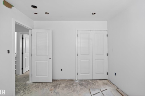 Bright interior space featuring white walls and a bi-fold closet door - 151 Kidd Crescent, Leduc, AB - Indoor Photo Showing Other Room