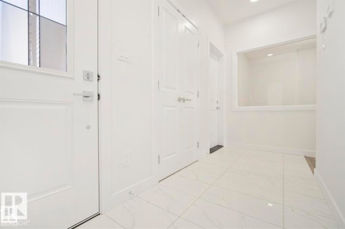 Entryway featuring bright white walls, large format tile flooring, and recessed lighting - 151 Kidd Crescent, Leduc, AB - Indoor Photo Showing Other Room