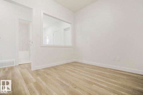 Room featuring light wood-finish flooring, white walls, and white baseboards - 151 Kidd Crescent, Leduc, AB - Indoor Photo Showing Other Room