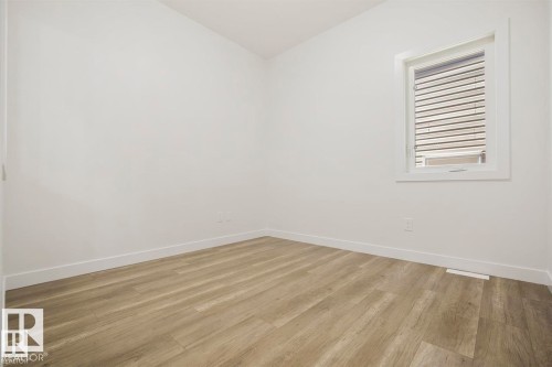 Bright room featuring light wood-finish flooring, white walls, and a single window with white trim and blinds - 151 Kidd Crescent, Leduc, AB - Indoor Photo Showing Other Room