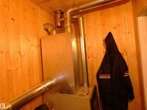 Located in the bathroom, alongside a small HW tank. - 307 Willow Place, Rural Barrhead County, AB 