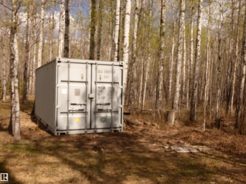 Sea can storage, located at the South side of the cottage. 24' in length...to hold the "extras" you don't know quite what to do with!  There's also an older, metal storage shed that will stay too. - 307 Willow Place, Rural Barrhead County, AB 